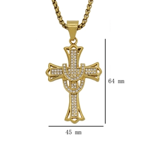 Macro detail of 18k gold plated stainless steel cross pendant with cubic zirconia
