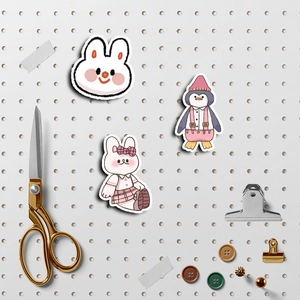 Flat lay of cute peach theme stickers on pegboard with stationery and DIY craft tools