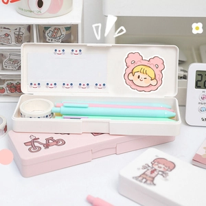 Close-up of cute peach stickers decorating a pink and white cream-colored pencil case