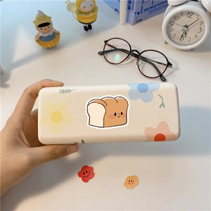 Detailed view of cute toast and floral pattern on a cream-colored cartoon eyeglass case