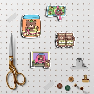 Close-up of cute cartoon bear stickers for planners with creative stationery props