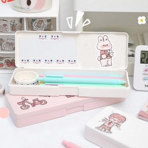 Macro view of white and pink minimalist desk organizers with cute rabbit stickers