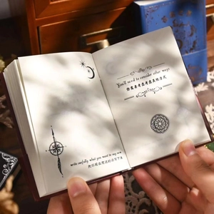 Vintage Book of Answers featuring celestial patterns and bilingual guidance text