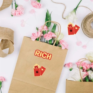 Brown kraft gift bag with yellow RICH text and floral decor on a white background