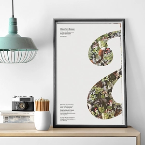 Detail of forest themed art poster with animal illustrations and black frame in a home setting