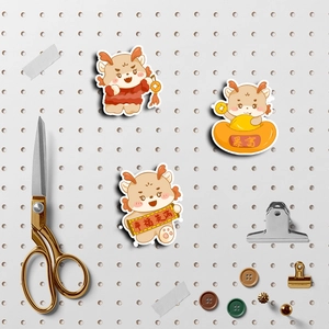 Macro view of Chinese Dragon New Year stickers on a white pegboard with stationery props