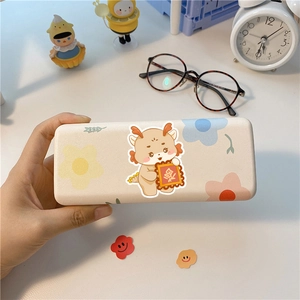 Detail of cartoon dragon glasses case with floral patterns and matte textured finish