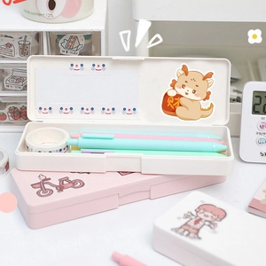 Close-up of Morandi pens and pink stationery case with cute dragon year stickers