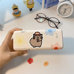 Close-up of a cream storage case featuring a cartoon capybara and floral patterns
