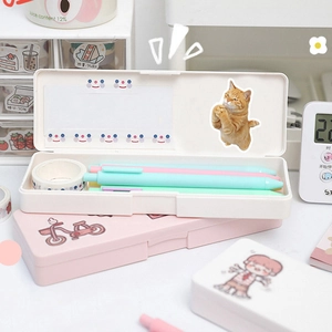 Detailed view of cat and dog stickers on stationery boxes with pastel pens and tape