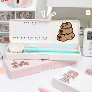 Detail of pink and white plastic stationery boxes with cute capybara cartoon stickers