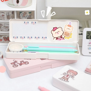 Detail of cream white and pink stationery boxes with cute bear prints and pens