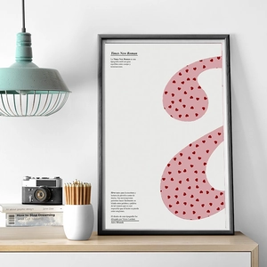 Pink heart typography art poster with black frame in a cozy Nordic home office setting
