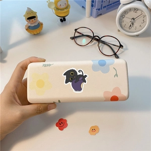 Detail of cute black cat pattern on a cream rectangular stationery box with floral motifs