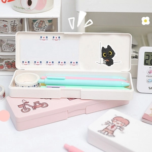 Detail of cute black cat stationery box set with macaron pens and decorative tape