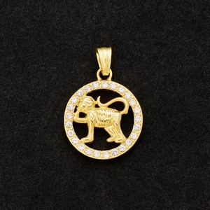 Macro view of gold-plated monkey zodiac pendant with sparkling zircon gemstones