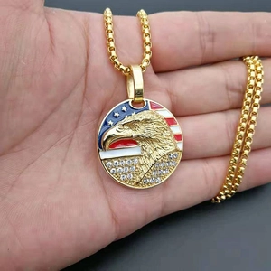 Detail of gold eagle pendant with American flag pattern and sparkling crystal rhinestones