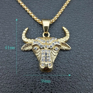 Detailed view of gold plated bison pendant with white rhinestones measuring 41mm by 38mm