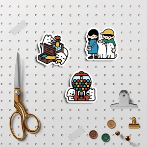 Close-up of cute cartoon white dog stickers on a pegboard with stationery accessories