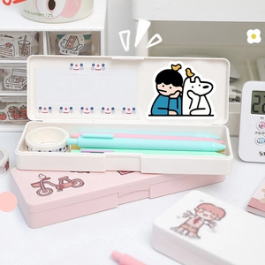 Close-up of cream and pink stationery cases with cute cartoon puppy stickers and pens