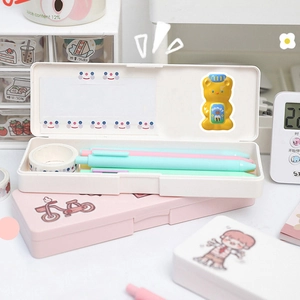 Detail of cute 3D stickers on white and pink stationery boxes in a cozy desk setup
