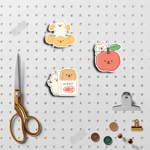 Cartoon bear stickers featuring cute fruit and animal designs on a desktop pegboard