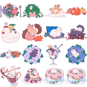 Close-up of cute cartoon cat stickers featuring pink cakes and pastel tulip themes