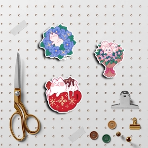 Macro detail of cute cartoon cat stickers featuring floral and coffee cup designs