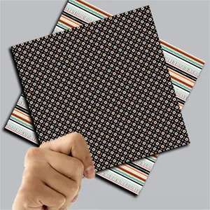 Detail showing two sheets of vintage Halloween scrapbook paper with retro ethnic patterns