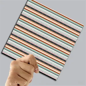 Close-up of vintage Halloween scrapbook paper with orange and black wavy stripe patterns