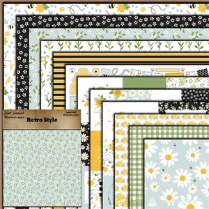 Detail view of various retro bee and sunflower patterned scrapbook papers stacked together