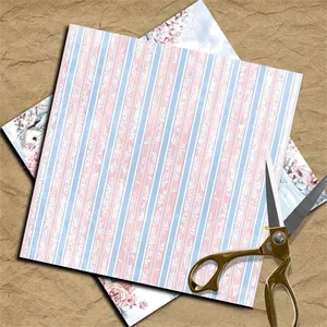 Macro view of vintage floral scrapbook paper with striped patterns and golden scissors