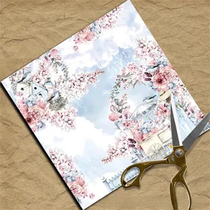 Detail of floral vintage scrapbook paper with blue birds and a gold handle scissor accessory