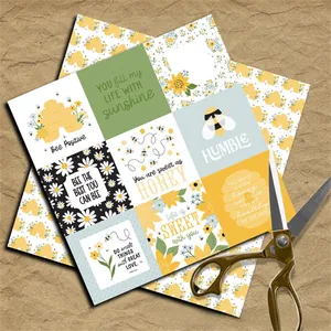 Detail of vintage honey bee scrapbooking paper with motivational quotes and gold scissors