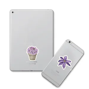 Detail of vintage purple flower stickers applied on mobile phone and tablet back