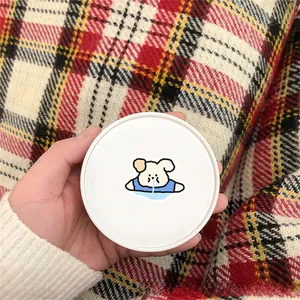 Close-up of a white round storage container featuring a cute crying bear cartoon design