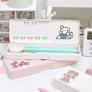 Detail view of cute pink and white plastic stationery cases with cartoon bear prints