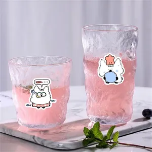 Hammered glass cup set with cute cartoon cat illustrations on marble tray