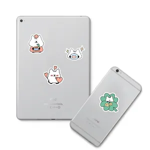 Detailed view of cute cartoon puppy stickers decorating the back of a white tablet