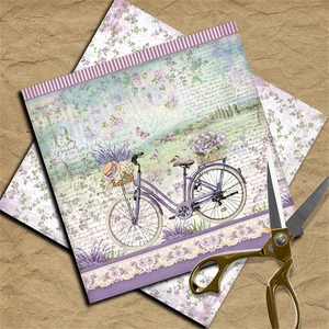 Macro detail of vintage scrapbook paper featuring lavender, bike and floral motifs