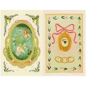 Close-up of vintage artistic paper with mermaid illustrations and fairytale motifs