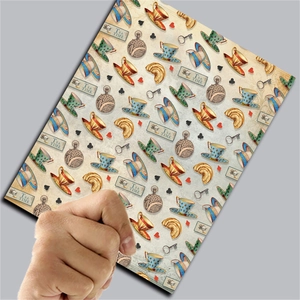 Detail of vintage Alice tea time decorative scrapbooking paper held by a person