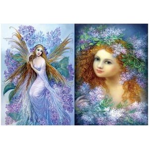 Macro detail of vintage fantasy angel stickers and floral scrapbooking paper sheets