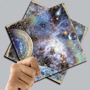Macro detail of vintage blue starry night scrapbooking paper with gold foil edge and script