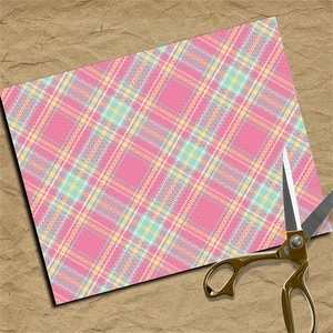 Pink plaid scrapbook paper with lace patterns near golden vintage scissors on kraft base