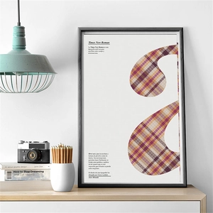 Detail of pink plaid decorative art print with vintage camera and desk accessories