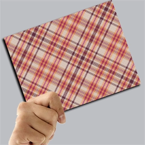 Close-up of vintage pink plaid scrapbook paper with colorful checkered pattern details