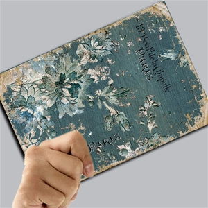 Close-up of vintage blue floral collage paper with French Paris address and weathered texture