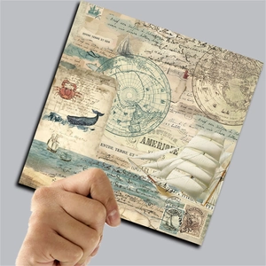 Close-up of vintage world travel scrapbooking paper with nautical maps and French script