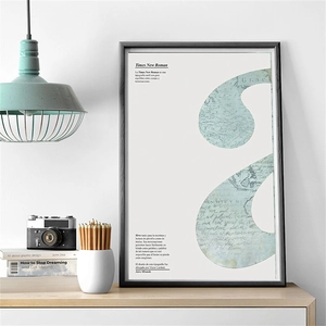 Detail view of a vintage world map art print in a minimalist black frame on a wooden desk